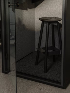Interior of a Berlin acoustic focus pod showing the stool and acoustic lining